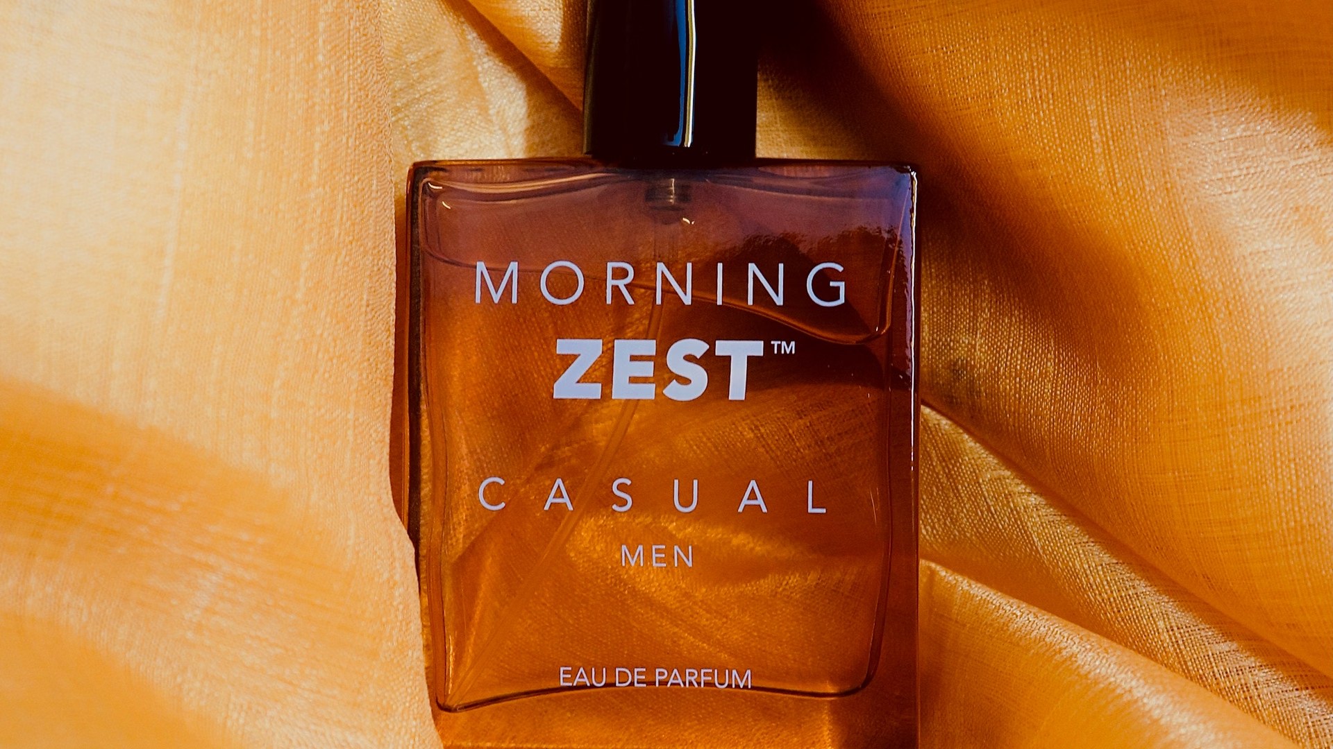 Warm amber satin fragrance editorial